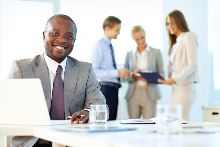 Portrait of a smiling businessman being at his workplace